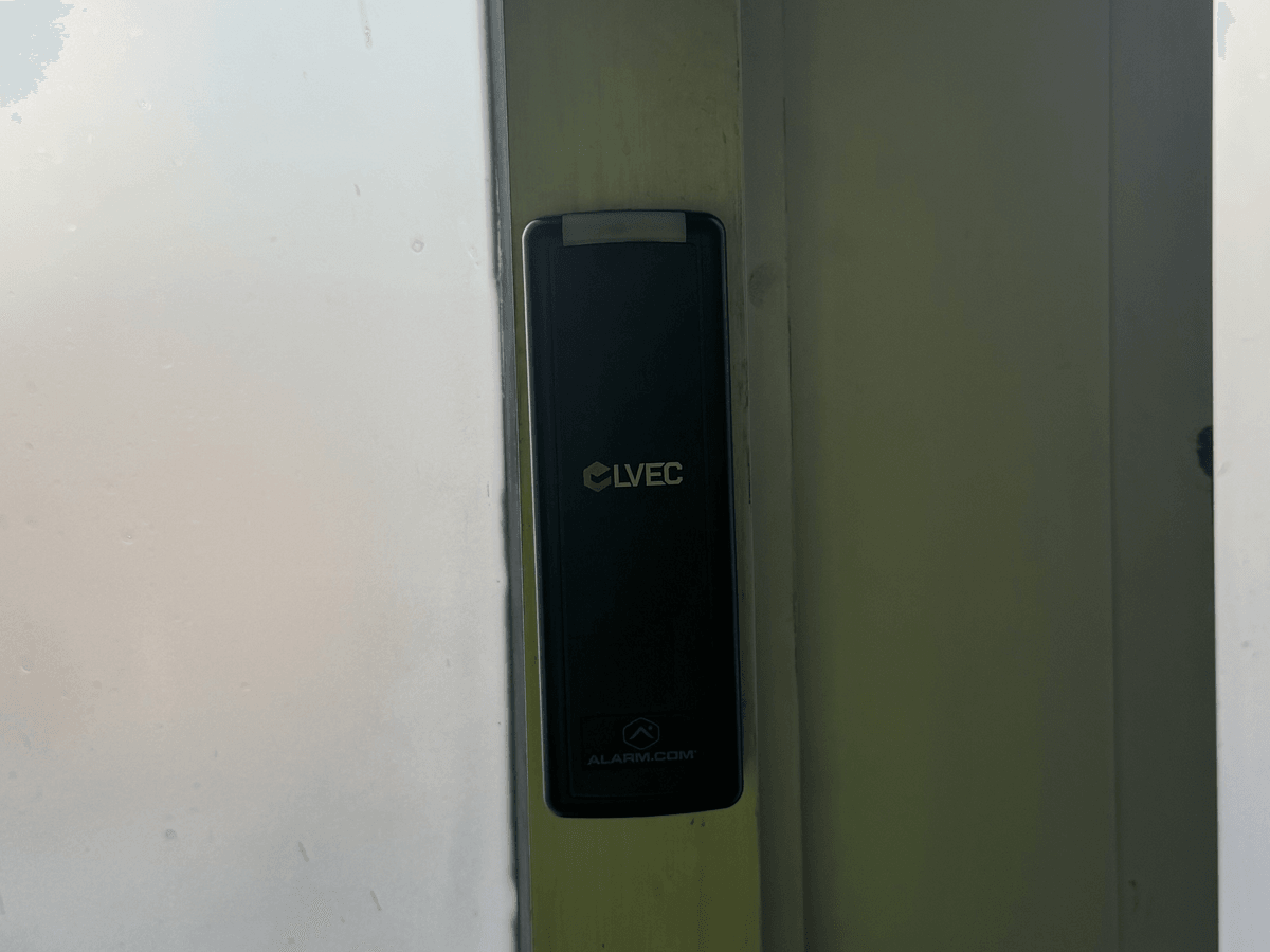 LVEC badge reader installed on a glass door frame