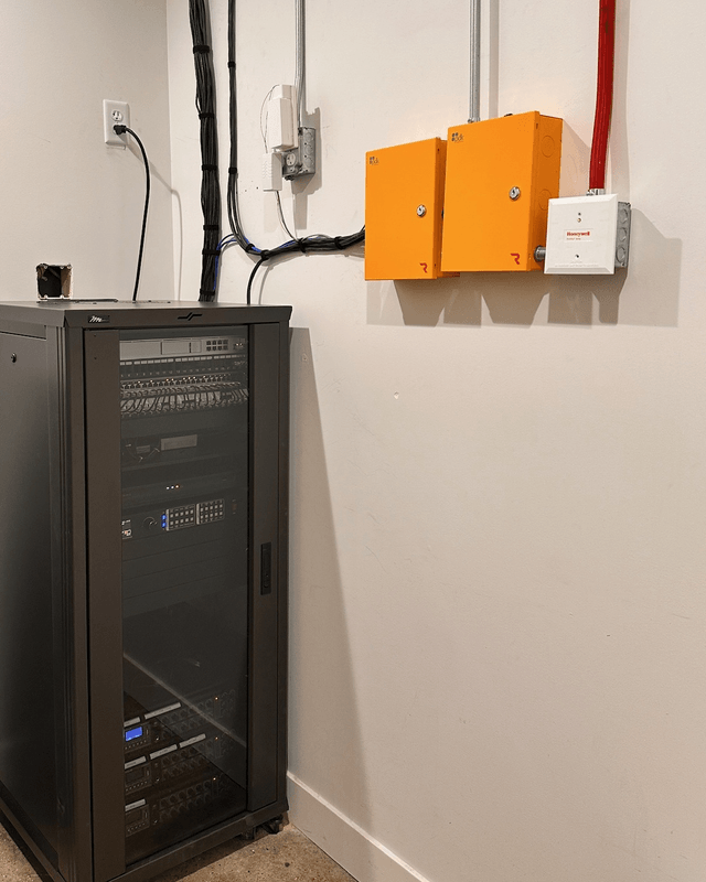 Network rack beside two access control panels