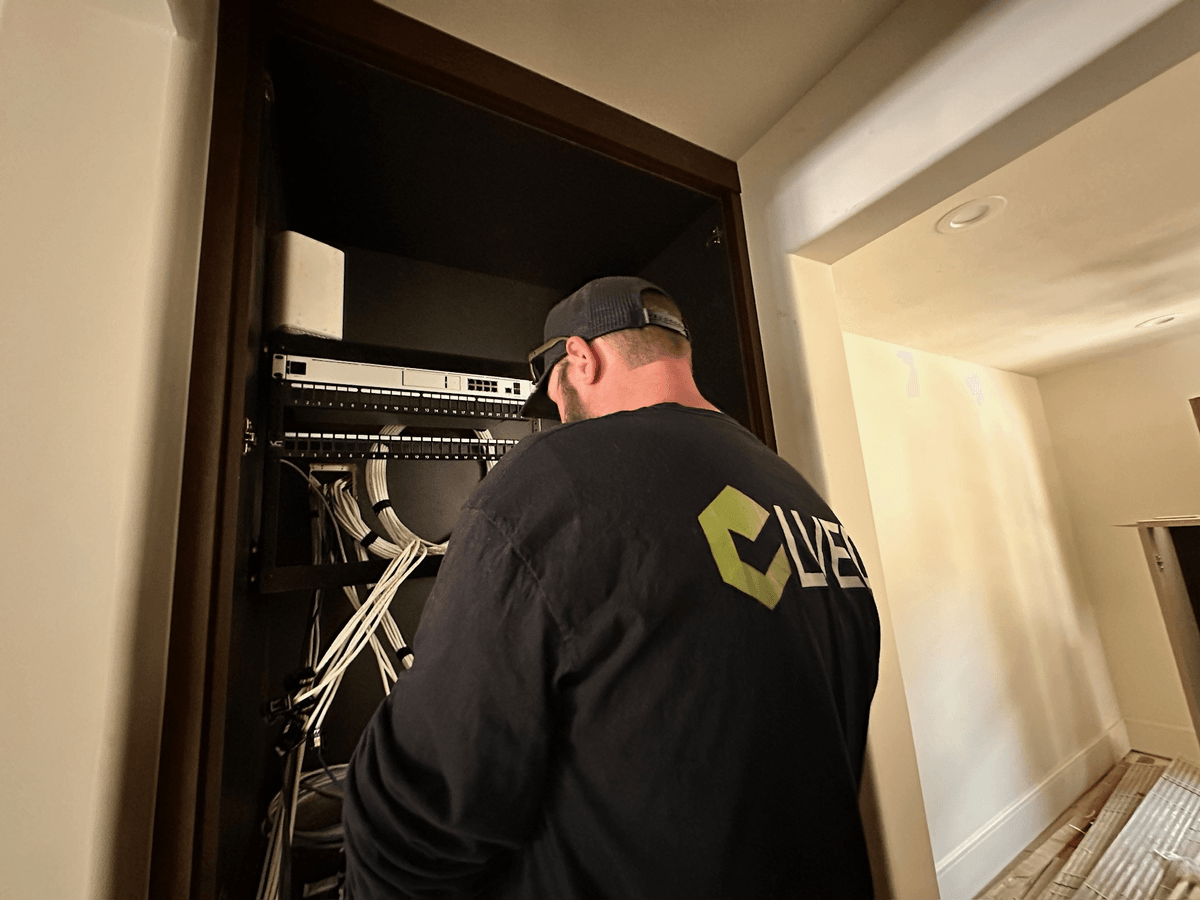 LVEC technician terminating cables in a network rack